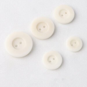 natural corozo buttons with wide edges two eyes and protruding bottoms for vintage vest pants