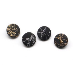 Metallic matte flat button with black cracks, brushed painted button